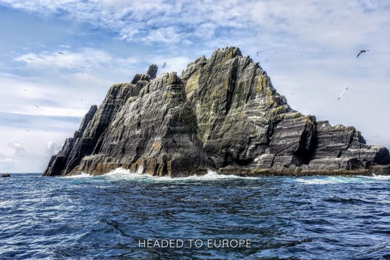The jagged, towering sea cliffs of Skellig Michael rise dramatically from the ocean under a sky filled with seabirds, securing its spot as one of the most cinematic and Instagrammable places in Ireland.