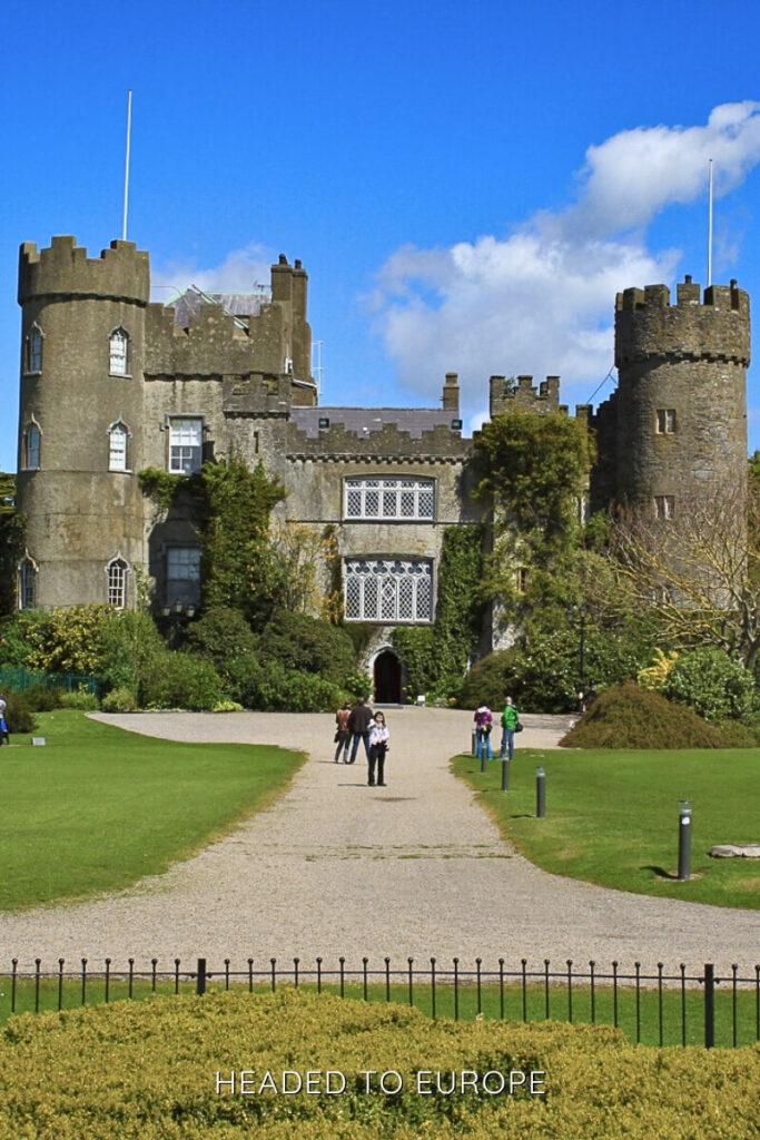 Malahide Castle’s ivy-covered towers and lush garden entrance under a bright blue sky make it one of the top Instagrammable places in Ireland near Dublin.