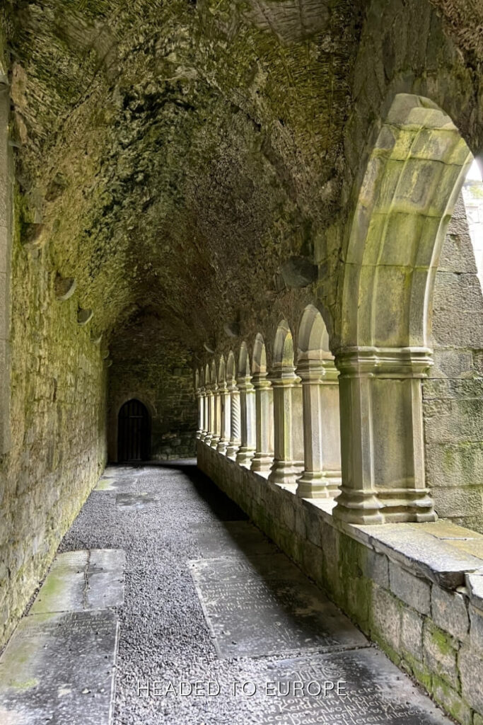 A mossy stone cloister with arched windows and historic atmosphere in Sligo, offering a quiet moment of reflection during Weekend Breaks in Ireland.