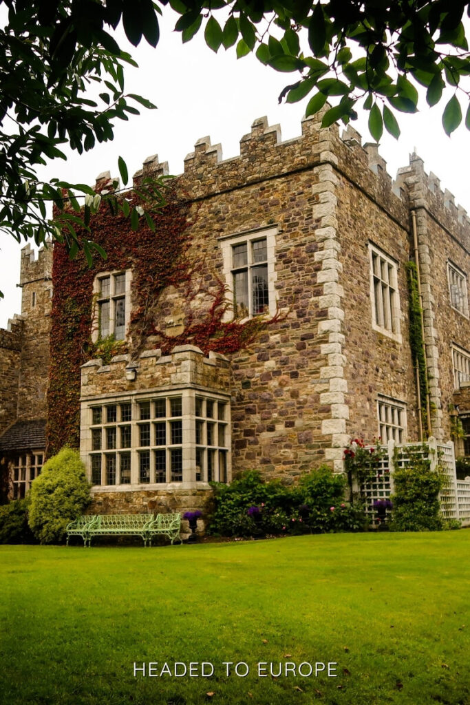 A stately ivy-covered manor with manicured lawns and stone architecture in Waterford, ideal for historical and relaxing Weekend Breaks in Ireland.